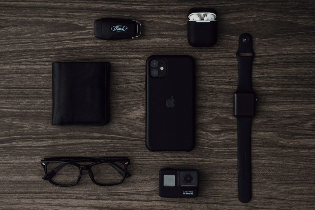 Flat lay of modern gadgets on wood surface, perfect for technology-themed projects.